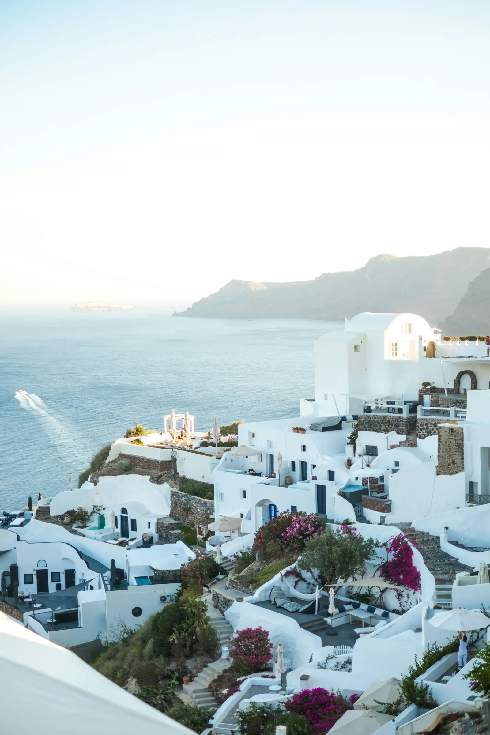 White buildings on a Santorini cliffside above the sea